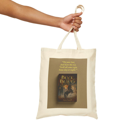 Black Beauty Tote Bag — mockup with hand holding the bag